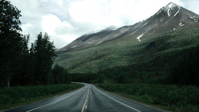 image of a road running through mountains