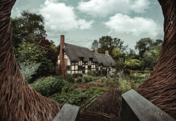English cottage surrounded by green forest